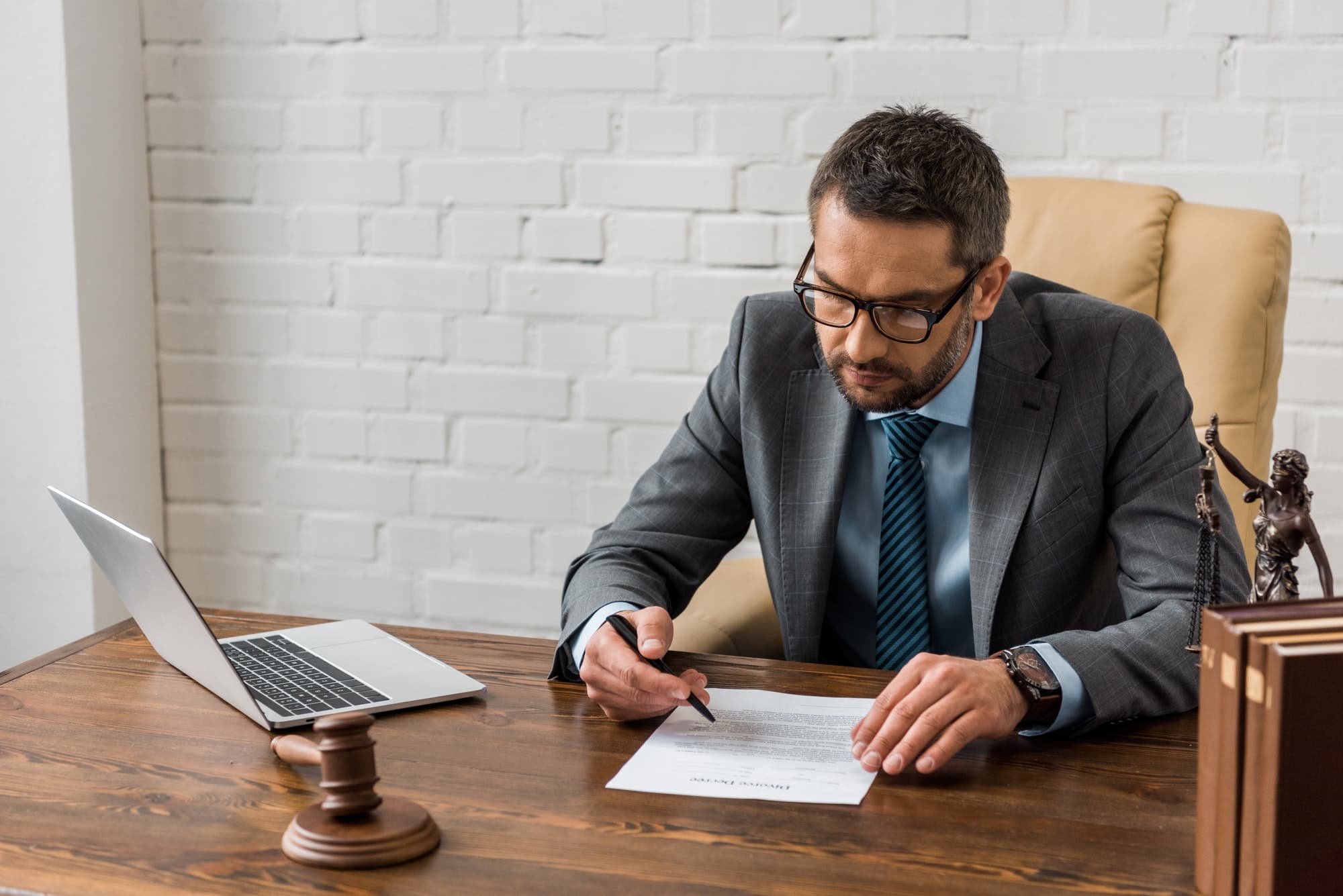 Male lawyer working with documents in office
